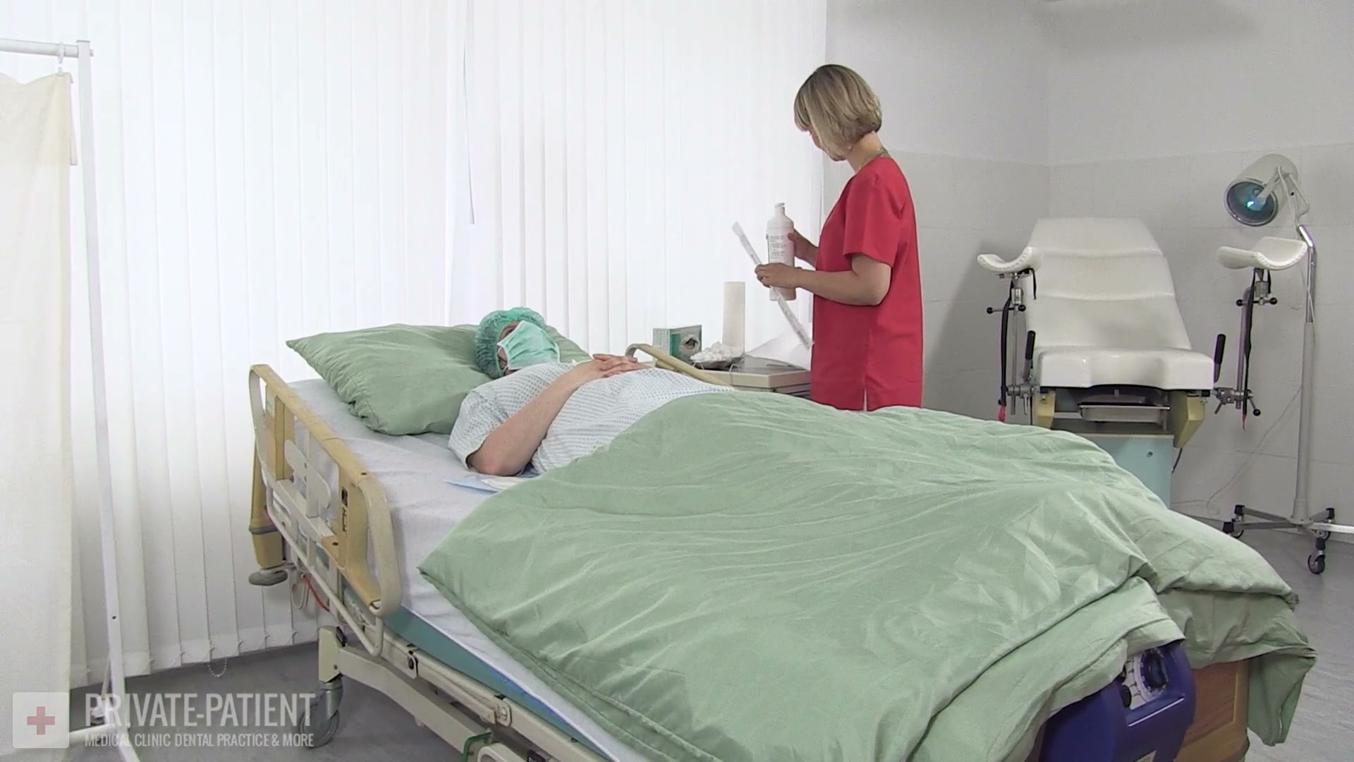 Free video frame from Pelvic Organs 01 private-patient featuring Dr. Eve in red scrubs conducting a clinical pelvic examination reviewed by Mistress Katharina Amara