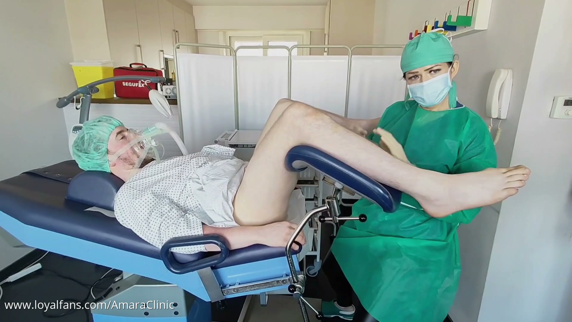 Mistress Katharina Amara Klysma free video frame showing the enema administered before the clinical prostate examination at Amara Fetish Clinic